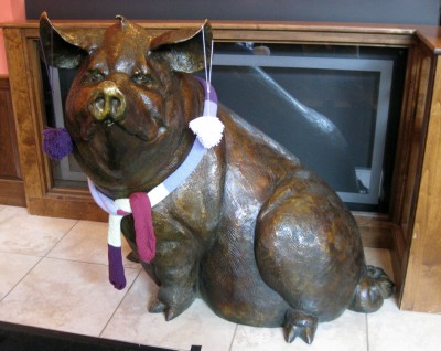 bronze pigs look better with scarves and pom pom earrings.